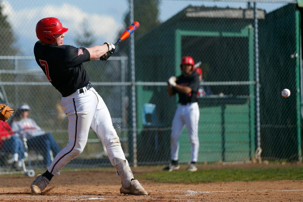 Snohomish’s Austin Baalman chops a ball to the left side during a matchup against Arlington on April 14 at Earl Torgeson Field in Snohomish. (Ryan Berry / The Herald)
