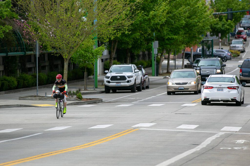Phillip Buffington rides up Hoyt Avenue to the Everett Public Library after his morning bicycle commute from Capitol Hill. (Ryan Berry / The Herald)
