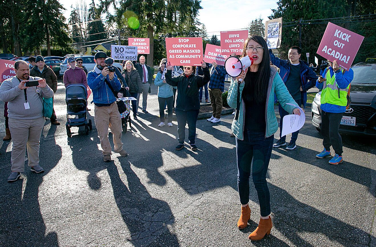 Vivian Dong, the founder of Safe Lynnwood, leads a group of protesters from the future site of a methadone clinic to the nearby Alderwood Boys & Girls Club on Saturday, Jan. 14, 2023, in Lynnwood, Washington. (Ryan Berry / The Herald)