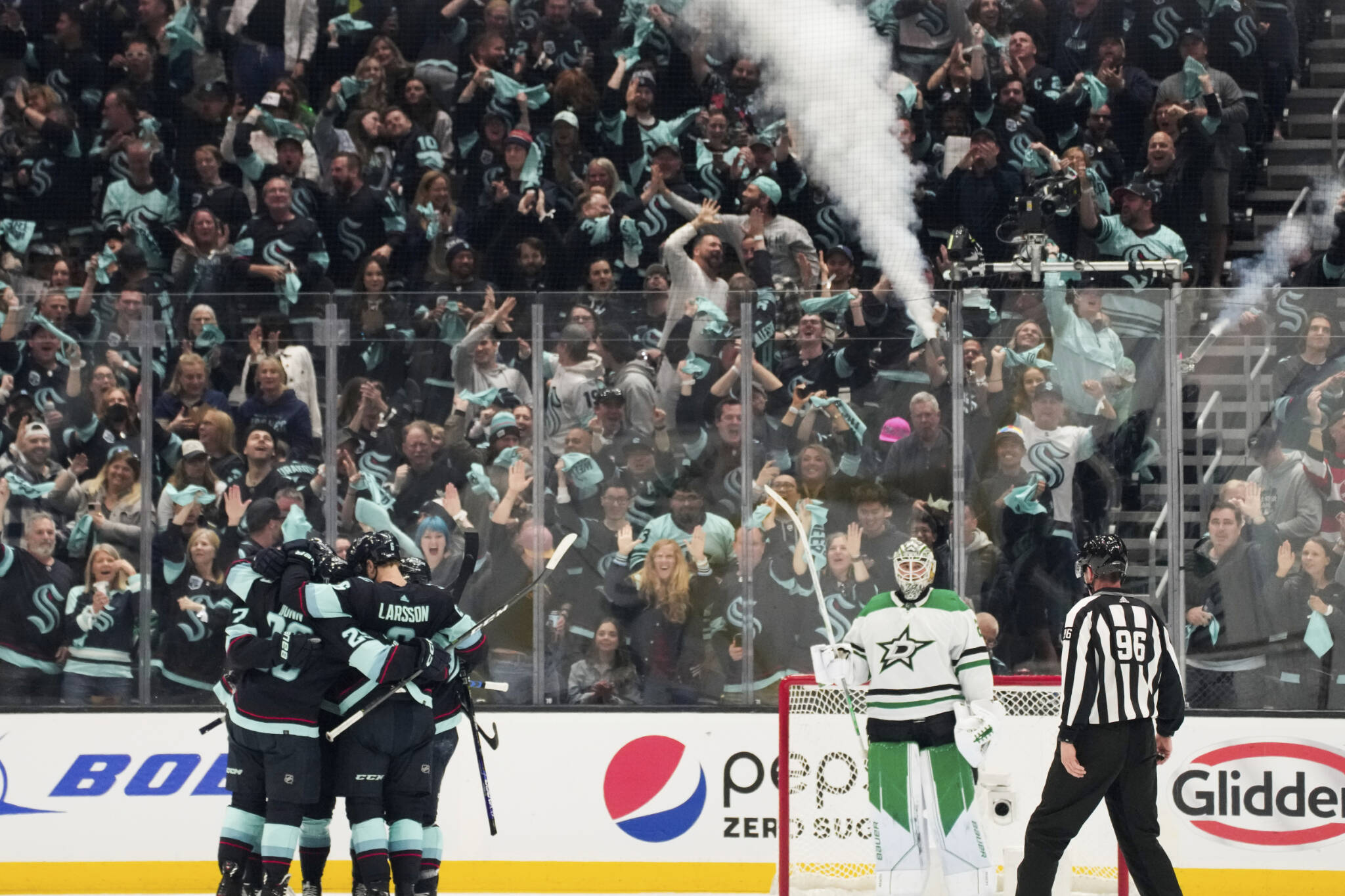 Kraken players and fans celebrate a goal as Stars goaltender Jake Oettinger looks on during the second period of Game 3 of a second-round playoff series Sunday in Seattle. (AP Photo/Lindsey Wasson)