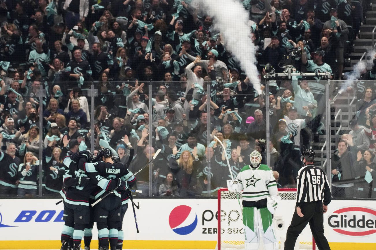 Dallas Stars goaltender Jake Oettinger looks on as the Seattle Kraken celebrate a goal during the second period of Game 3 of an NHL hockey Stanley Cup second-round playoff series Sunday, May 7, 2023, in Seattle. (AP Photo/Lindsey Wasson)