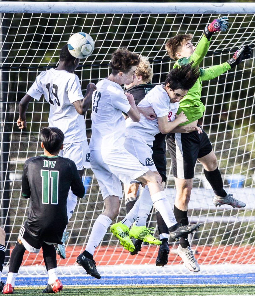 Mountlake Terrace players all leap in the air for a corner kick during the game against Mount Vernon on Tuesday, May 9, 2023 in Shoreline, Washington. (Olivia Vanni / The Herald)
