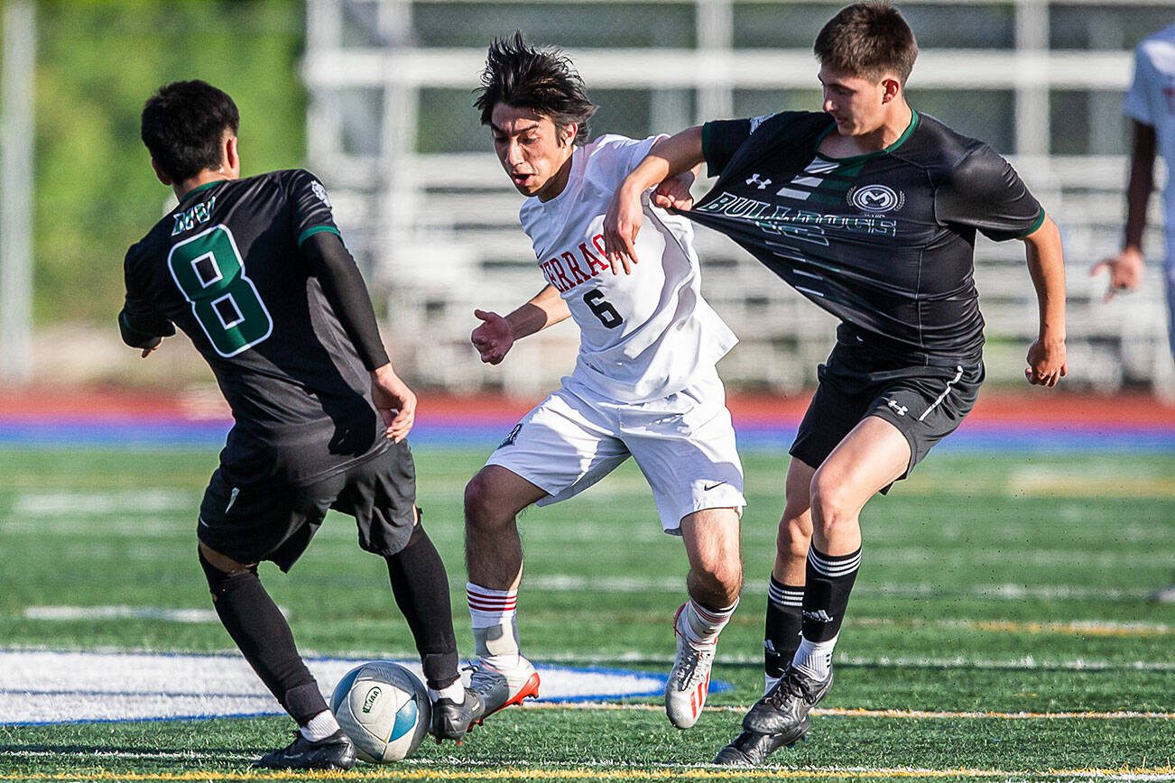 Mountlake Terrace’s Job Astudillo pulls the jersey of a Mount Vernon player while trying to get the ball during the game on Tuesday, May 9, 2023 in Shoreline, Washington. (Olivia Vanni / The Herald)