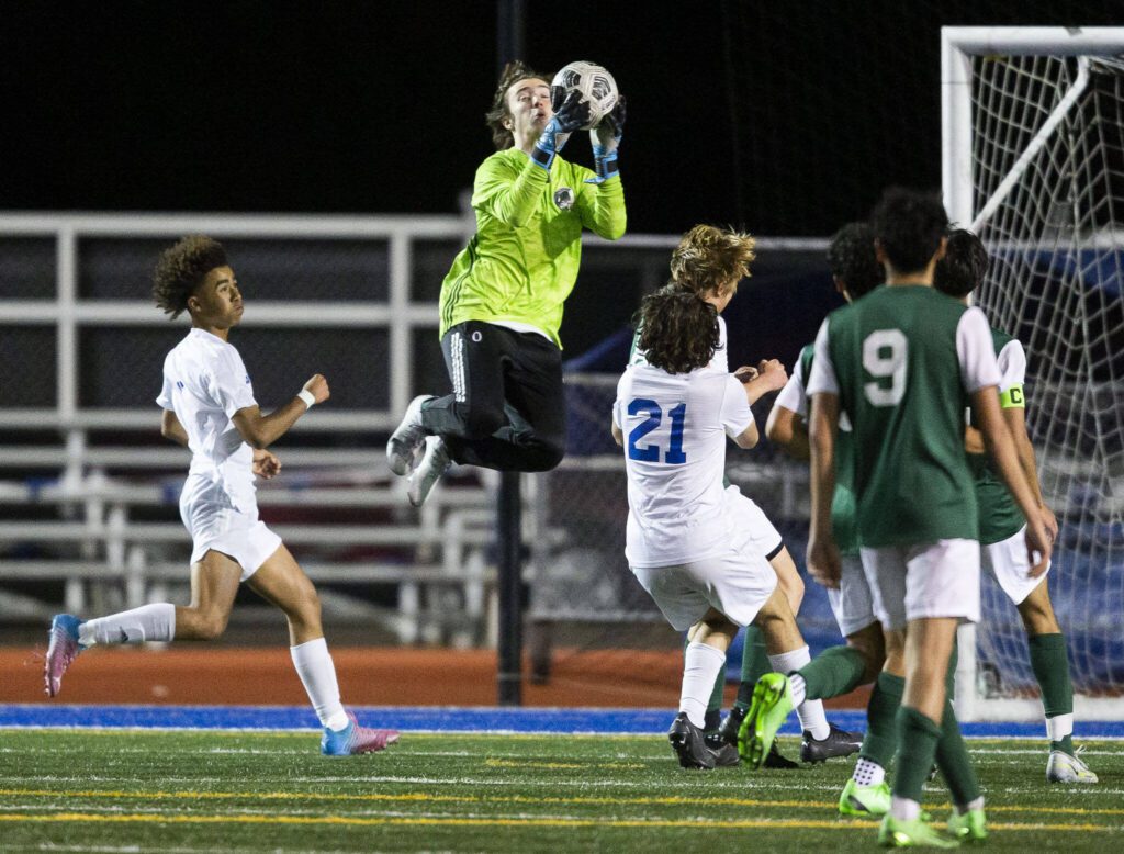 Edmonds-Woodway’s Gabriel Wilhelm leaps in the air to make a save during the game against Shorewood on Tuesday, May 9, 2023 in Shoreline, Washington. (Olivia Vanni / The Herald)
