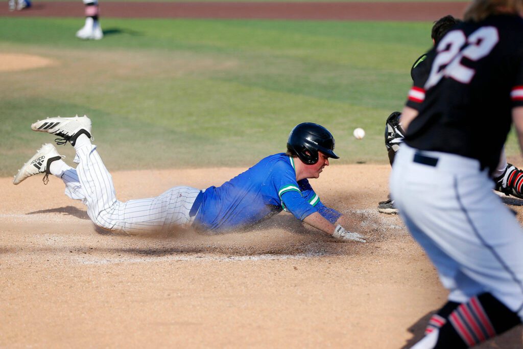 Shorewood’s Blake Gettmann slides in safe on Noah Fahey’s game-tying hit against Mountlake Terrace in a Wesco 3A District 1 semifinal on Tuesday, May 9, 2023, at Funko Field in Everett, Washington. (Ryan Berry / The Herald)
