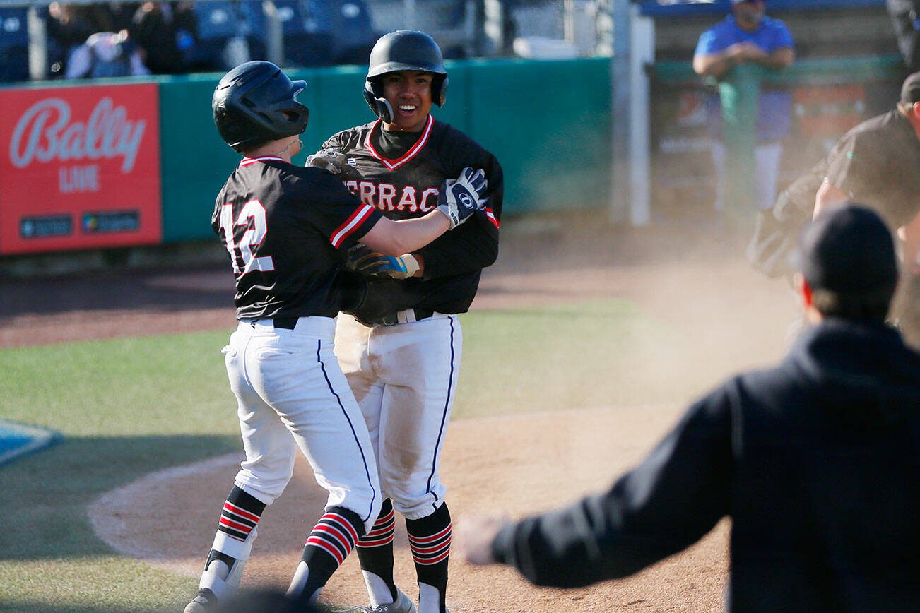 Mountlake Terrace’s Griffin Potter grabs Rominic Quiban after Quiban stole home for the eventual winning run against Shorewood in a Wesco 3A District 1 semifinal on Tuesday, May 9, 2023, at Funko Field in Everett, Washington. (Ryan Berry / The Herald)