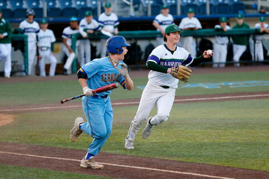 Edmonds-Woodway’s Jens Simonsen opts to throw to first on a dribbler in front of the mound against Ferndale in a Wesco 3A District 1 semifinal on Tuesday, May 9, 2023, at Funko Field in Everett, Washington. (Ryan Berry / The Herald)
