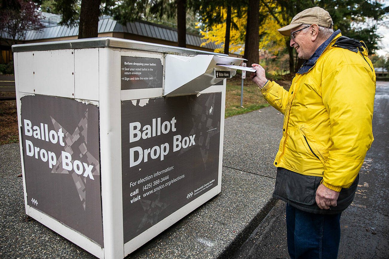 Dennis Michelson pushes his ballot into the drop box outside of Lynnwood City Hall on Wednesday, Nov. 2, 2022 in Lynnwood, Washington. (Olivia Vanni / The Herald)