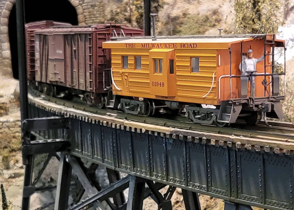 A model caboose crossing bridge on Swamp Creek & Western model railroad. (Photo by John Dineen)

