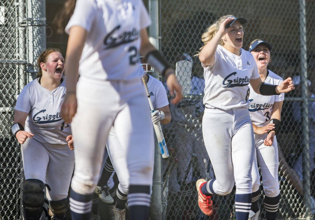 Glacier Peak players run onto the field to celebrate a win over Lake Stevens on Wednesday, May 10, 2023, in Snohomish, Washington. (Olivia Vanni / The Herald)
