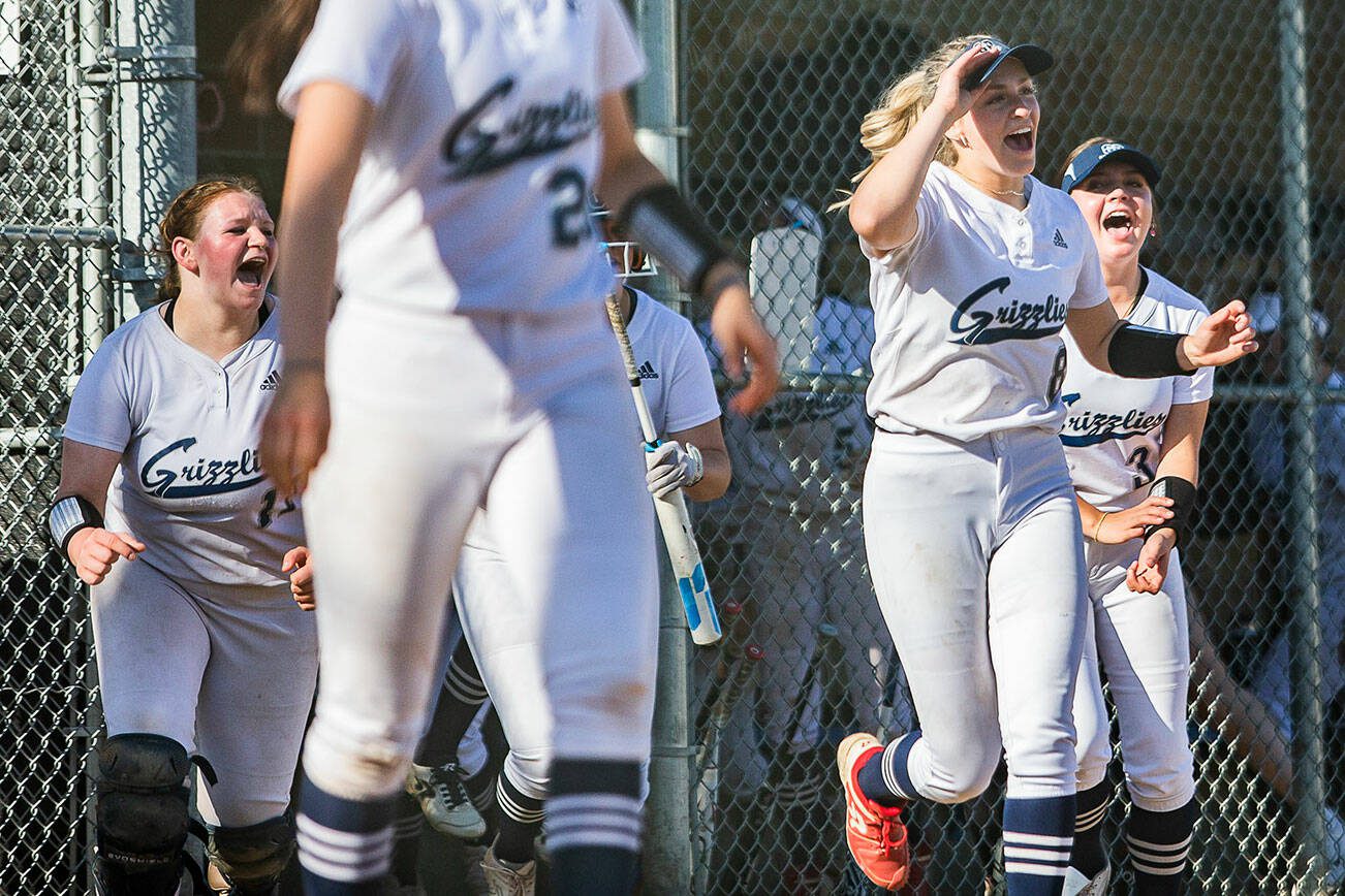 Glacier Peak players run onto the field to celebrate beating Lake Stevens on Wednesday, May 10, 2023 in Snohomish, Washington. (Olivia Vanni / The Herald)