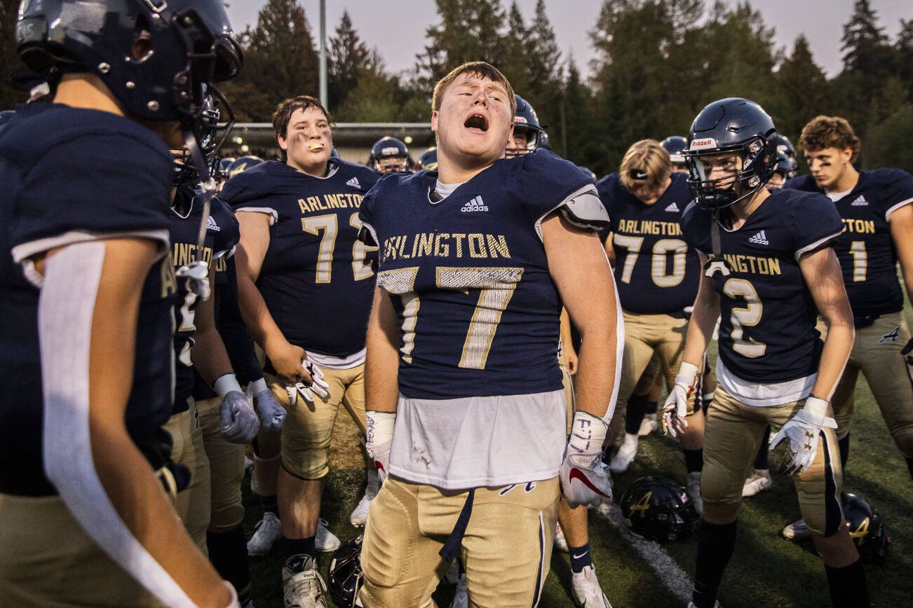 Arlington’s Wyatt Tilton gets his team pumped up before the the Stilly Cup against Stanwood on Friday, Sept. 30, 2022 in Arlington, Washington. (Olivia Vanni / The Herald)