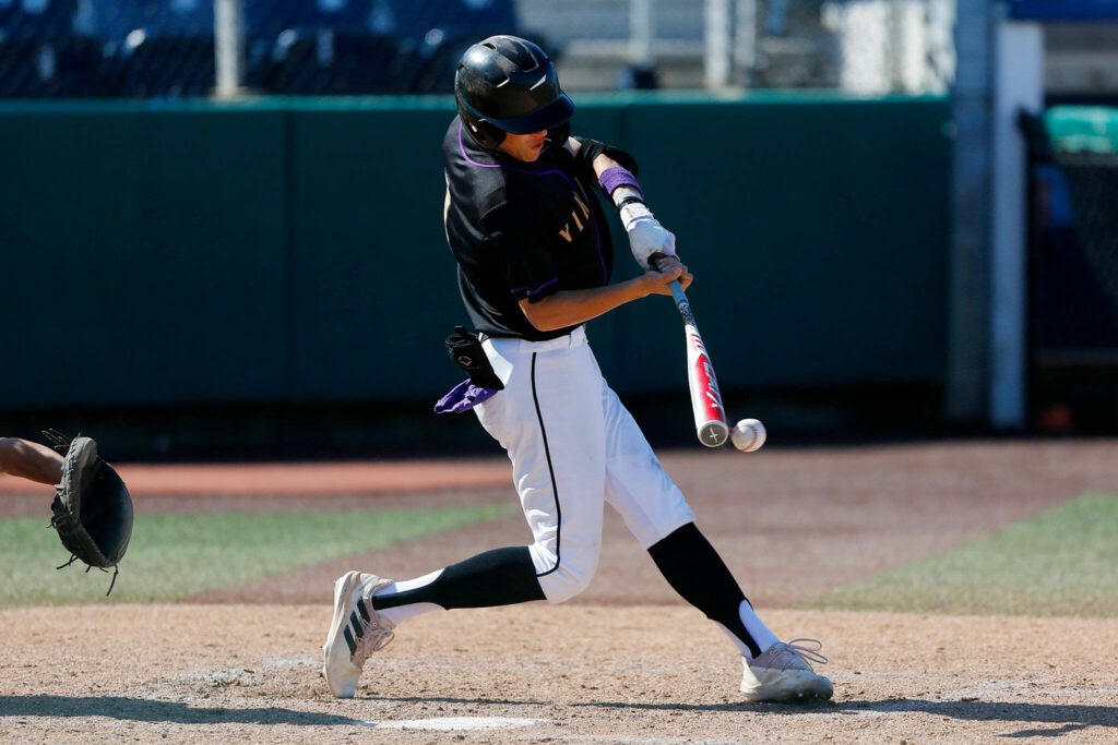 Lake Stevens’ Seth Mahler hits a hard grounder to the left side against Jackson during a Wesco 4A District 1/2 game on Thursday, May 11, 2023, at Funko Field in Everett, Washington. (Ryan Berry / The Herald)
