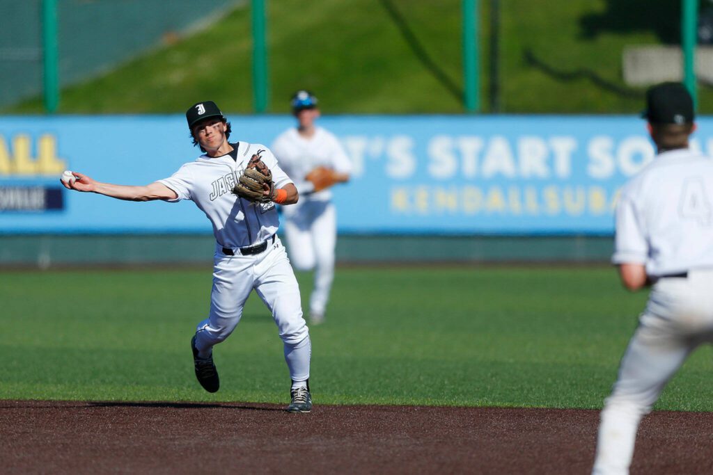 Jackson’s Evan Mothersbaugh throws out a Lake Stevens baserunner at first during a Wesco 4A District 1/2 game on Thursday, May 11, 2023, at Funko Field in Everett, Washington. (Ryan Berry / The Herald)
