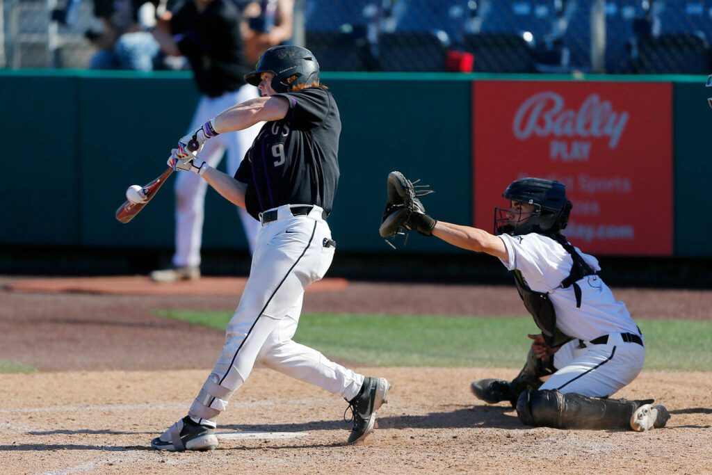 Lake Stevens’ TK Perkins makes solid contact on a flyout to left against Jackson during a Wesco 4A District 1/2 game on Thursday, May 11, 2023, at Funko Field in Everett, Washington. (Ryan Berry / The Herald)
