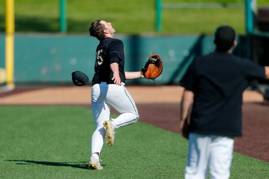 Lake Stevens first baseman Cody Osterholtz loses his cap while chasing a popup in foul territory against Jackson during a Wesco 4A District 1/2 game on Thursday, May 11, 2023, at Funko Field in Everett, Washington. (Ryan Berry / The Herald)
