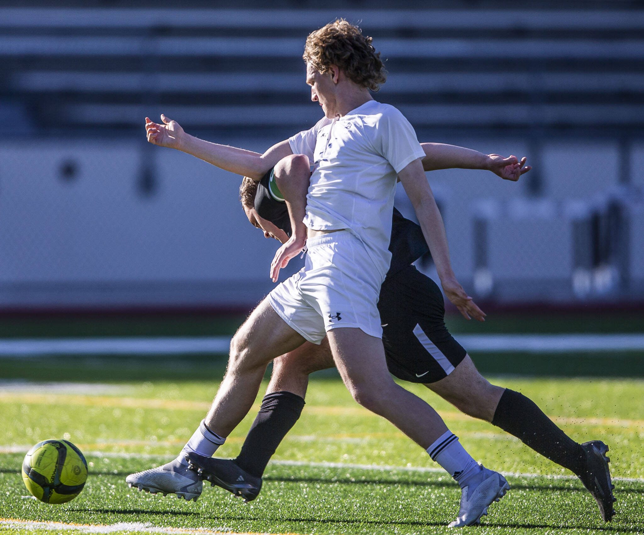 Jackson’s Jaden Oguda fights for the ball with Bothell’s Leif Rietz during the game on Thursday, May 11, 2023 in Everett, Washington. (Olivia Vanni / The Herald)