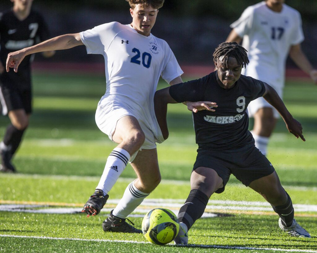 Jackson’s Jaden Oguda fights for the ball with Bothell’s Leif Rietz during the game on Thursday, May 11, 2023 in Everett, Washington. (Olivia Vanni / The Herald)
