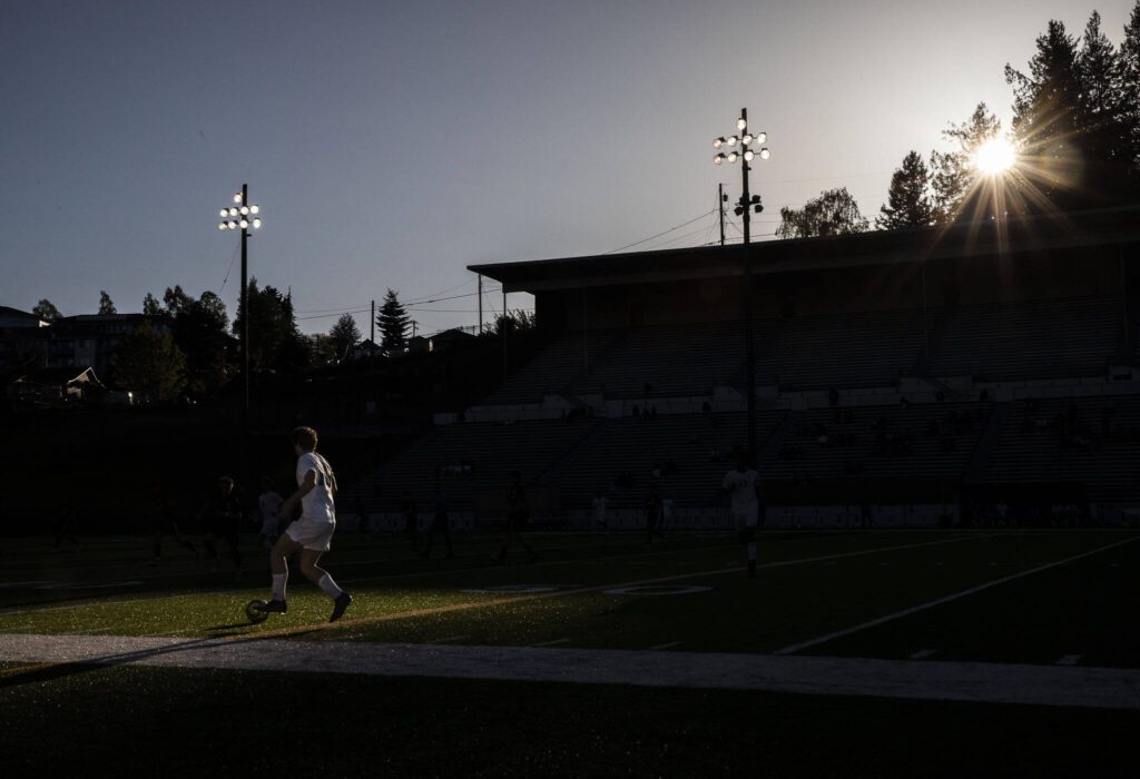 Bothell’s Lucas Renggli dribbles through a patch of sunlight on the field during the game against Jackson on Thursday, May 11, 2023 in Everett, Washington. (Olivia Vanni / The Herald)
