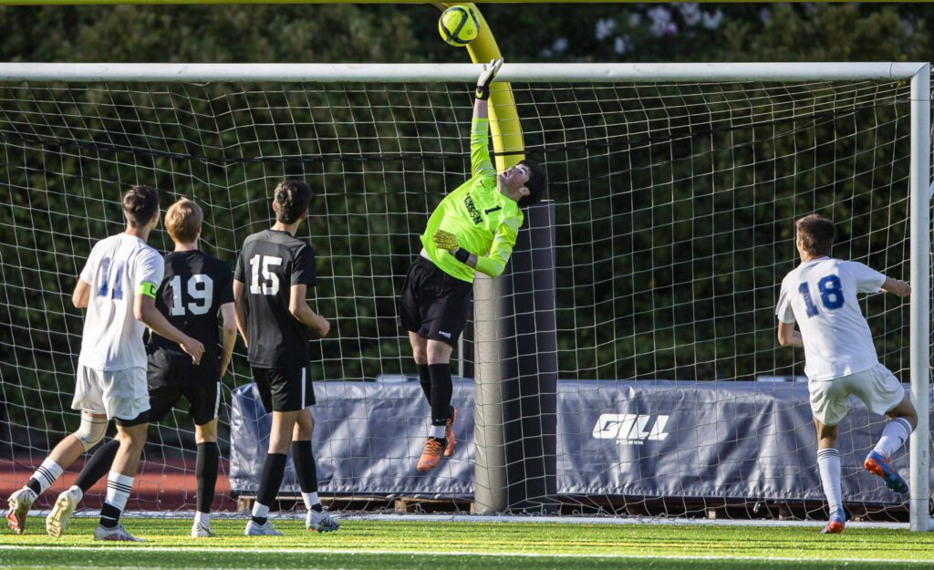 Jackson goalie Ben Ferguson tips shot up and over the goal during the game against Bothell on Thursday, May 11, 2023 in Everett, Washington. (Olivia Vanni / The Herald)

