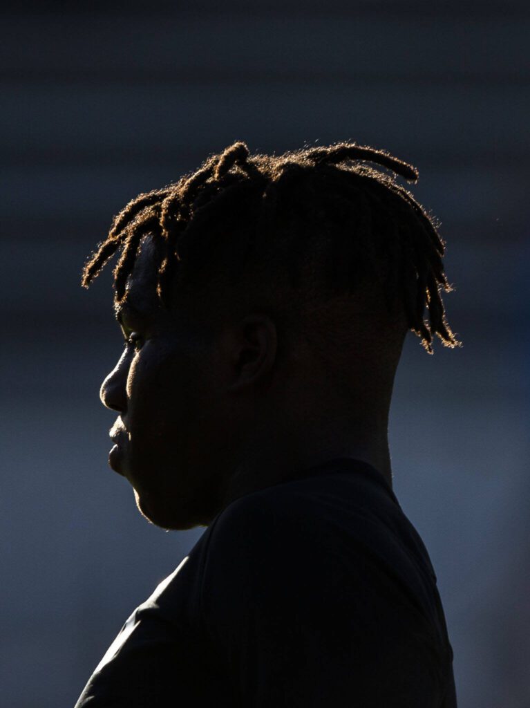 Sunlight illuminates Jackson’s Jaden Oguda during the game against Bothell on Thursday, May 11, 2023 in Everett, Washington. (Olivia Vanni / The Herald)
