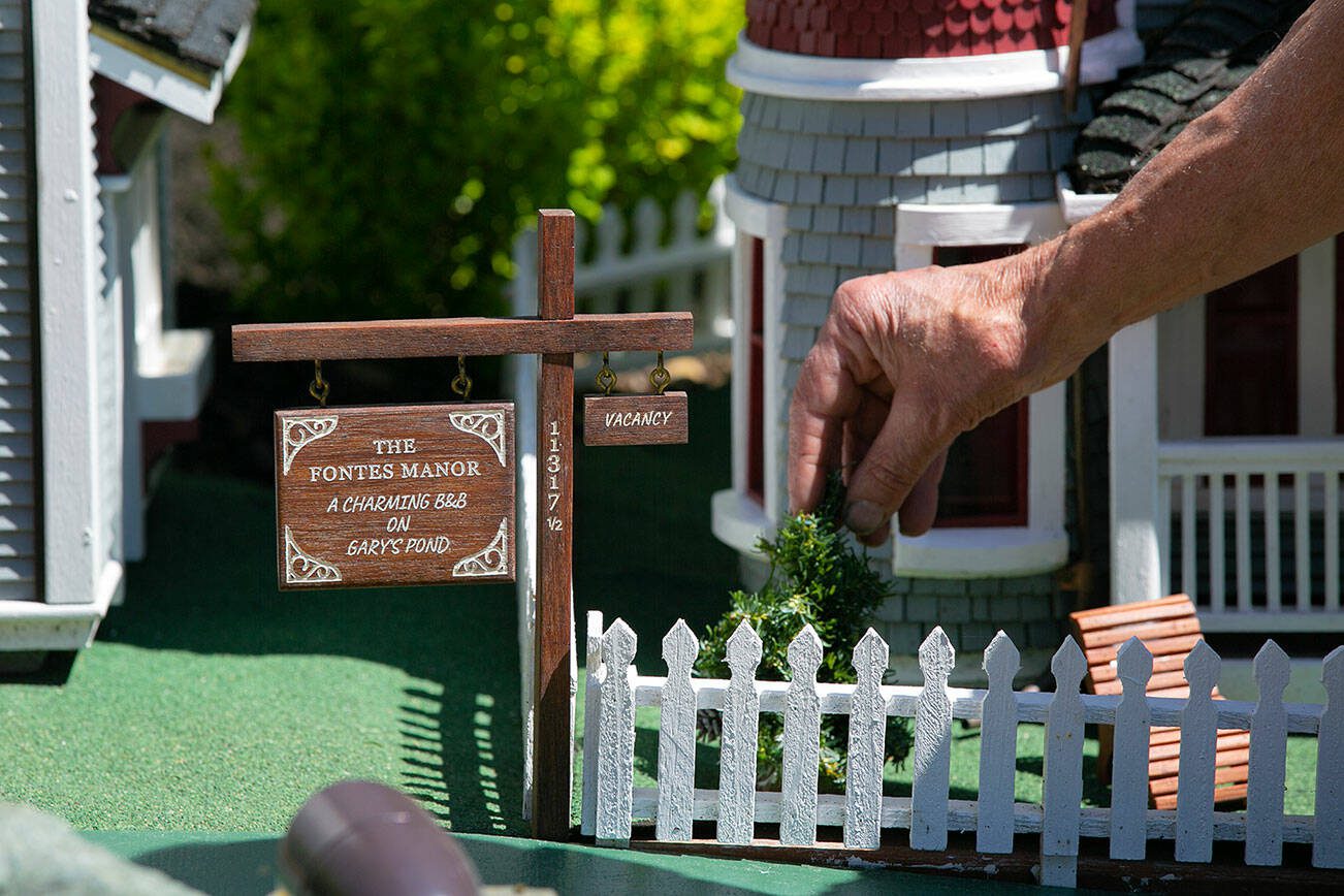 Gary Fontes uprights a tree that fell over in front of The Fontes Manor — a miniature handmade bed and breakfast — on Friday, May 12, 2023, at his home near Silver Lake in Everett, Washington. (Ryan Berry / The Herald)