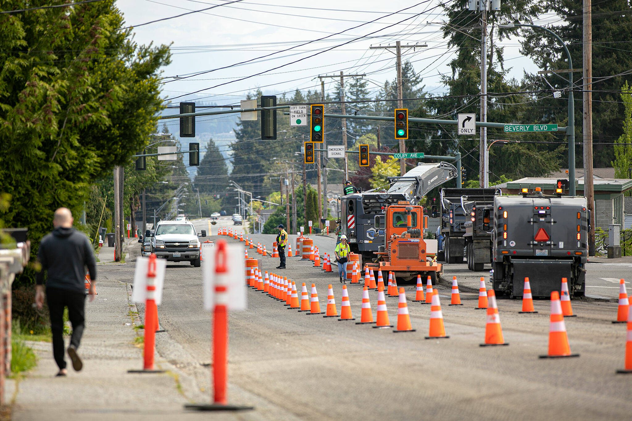 Crews from Reece Construction Company mill asphalt off of Madison Avenue near the intersection at Beverly during the beginning of construction on Tuesday, May 16, 2023, in Everett, Washington. (Ryan Berry / The Herald)