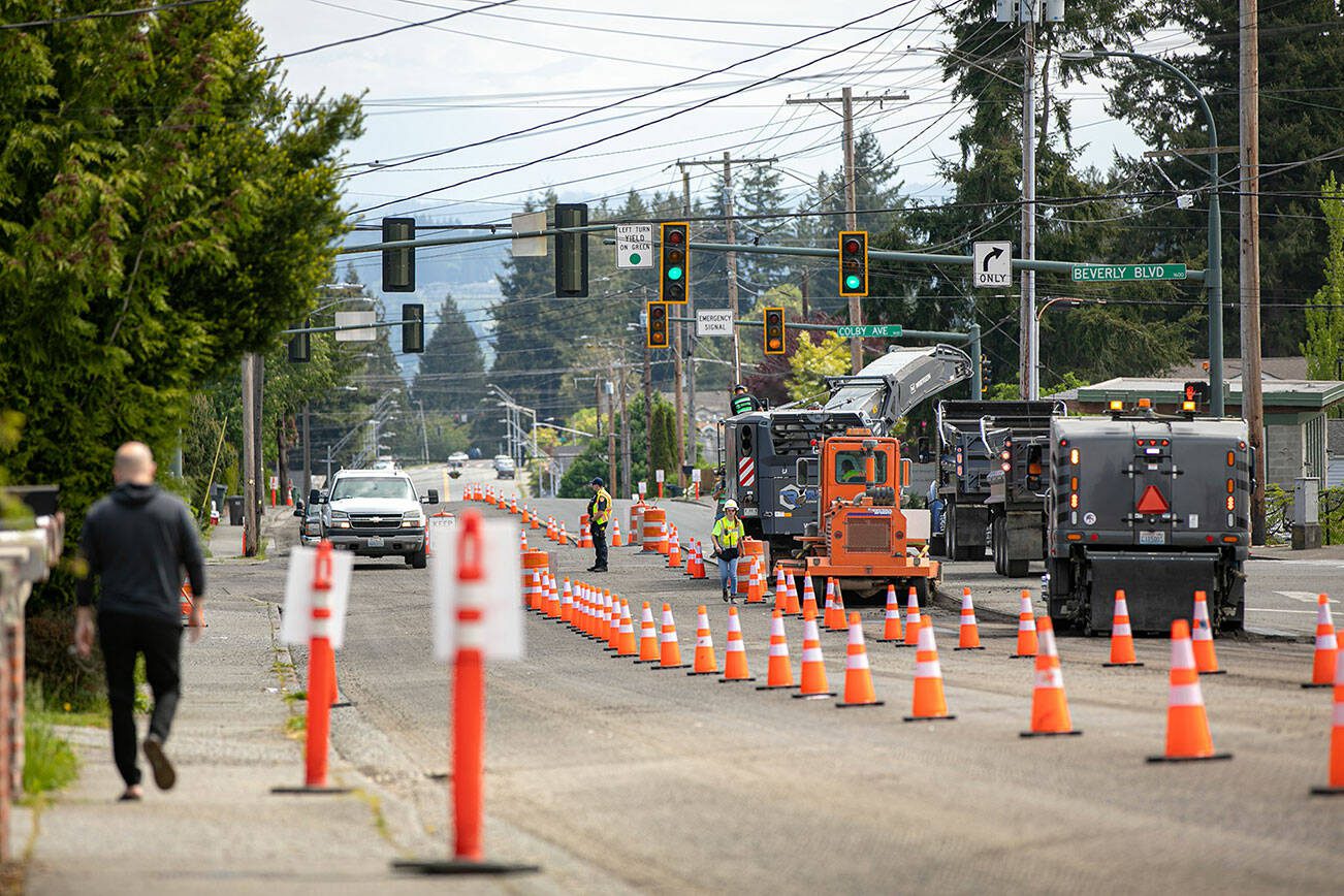 Crews from Reece Construction Company mill asphalt off of Madison Avenue during the beginning of construction on Tuesday, May 16, 2023, in Everett, Washington. (Ryan Berry / The Herald)