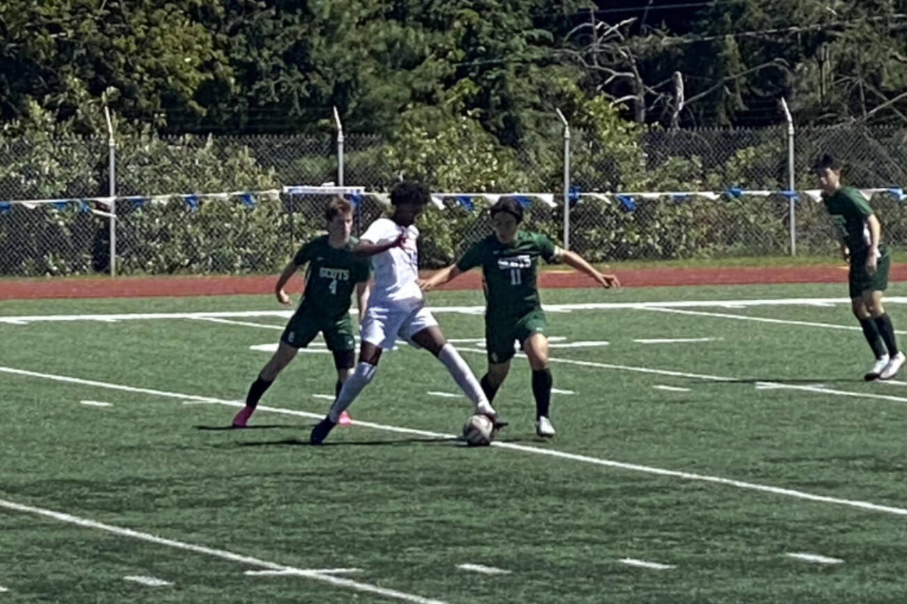 Shorecrest’s Malcolm Etches (4) and Kenny Ramirez-Moreno (11) and Mountlake Terrace’s Fedel Tewolde (18) battle for the ball during a winner-to-state Class 3A District 1 tournament game Saturday at Shoreline Stadium. (Nick Patterson / The Herald)