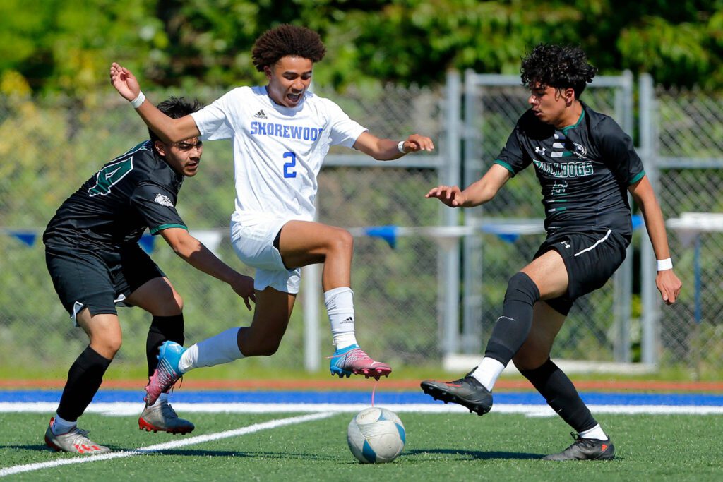 Shorewood’s Jackson Smith splits two defenders against Mount Vernon during the 3A District Championship match on Saturday, May 13, 2023, at Shoreline Stadium in Shoreline, Washington. (Ryan Berry / The Herald)
