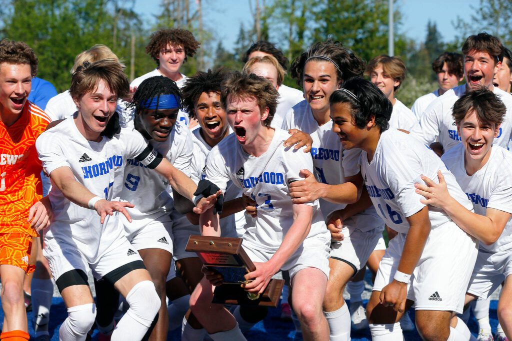 Shorewood players celebrate their victory over Mount Vernon in the Class 3A District 1 championship match Saturday at Shoreline Stadium in Shoreline. (Ryan Berry / The Herald)
