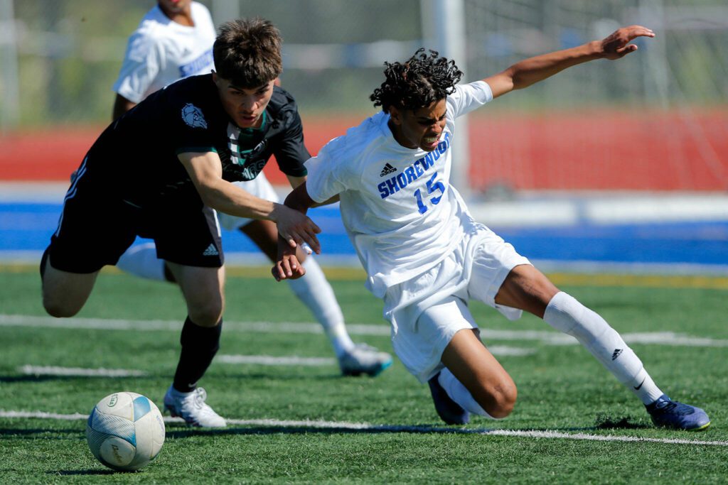 Mount Vernon’s Jonathan Mancillas-Garduno takes down Shorewood’s Matthew Bereket as the two race for the ball during the 3A District Championship match on Saturday, May 13, 2023, at Shoreline Stadium in Shoreline, Washington. (Ryan Berry / The Herald)
