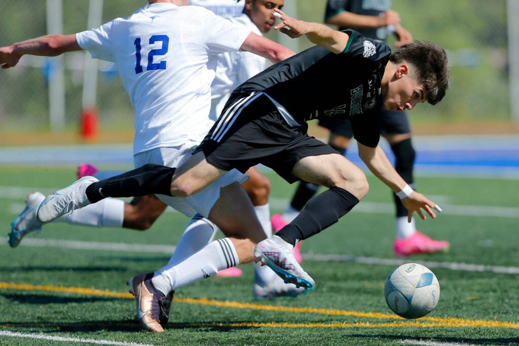 Mount Vernon’s Jonathan Mancillas-Garduno tries to retain possession of the ball against Shorewood during the 3A District Championship match on Saturday, May 13, 2023, at Shoreline Stadium in Shoreline, Washington. (Ryan Berry / The Herald)
