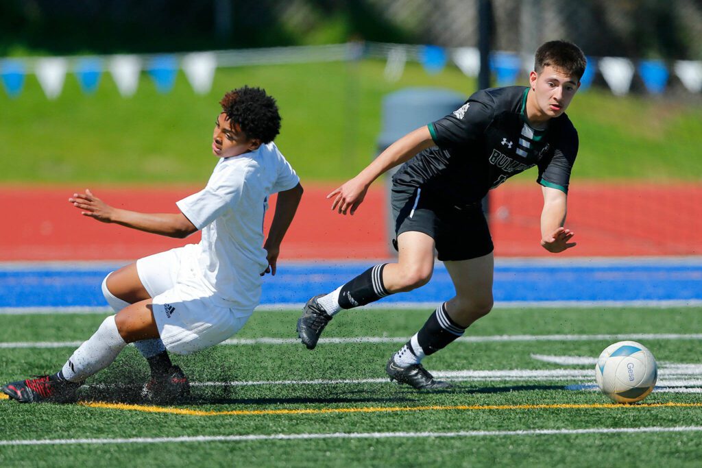 Mount Vernon’s Jose Gonzalez puts a defender to the turf while moving up the field against Shorewood during the 3A District Championship match on Saturday, May 13, 2023, at Shoreline Stadium in Shoreline, Washington. (Ryan Berry / The Herald)
