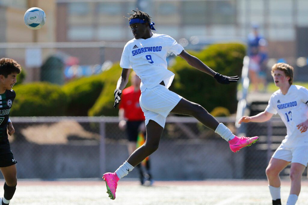 Shorewood’s Anthony Henry leaps to redirect a long ball against Mount Vernon during the 3A District 1 championship match Saturday at Shoreline Stadium in Shoreline. (Ryan Berry / The Herald)
