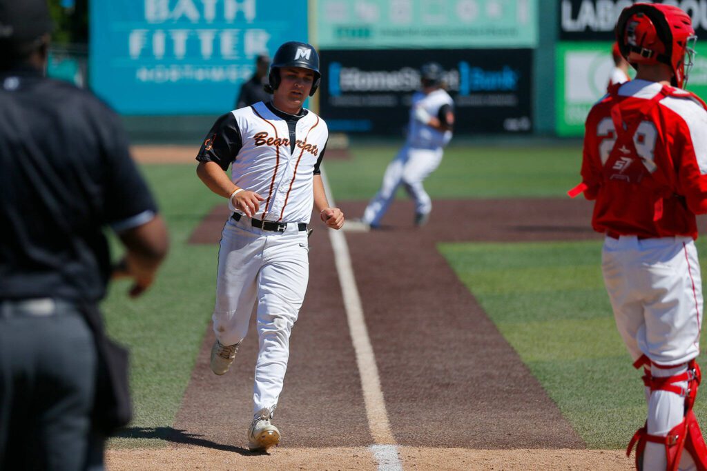Monroe’s Harlan Rowe scores a run against Stanwood in a winner-to-state consolation game on Saturday, May 13, 2023, at Funko Field in Everett, Washington. (Ryan Berry / The Herald)
