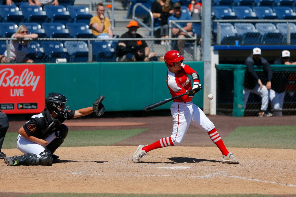 Stanwood’s Luke Palaniuk lines out to Monroe first baseman Rylan Hampton in a winner-to-state consolation game on Saturday, May 13, 2023, at Funko Field in Everett, Washington. (Ryan Berry / The Herald)
