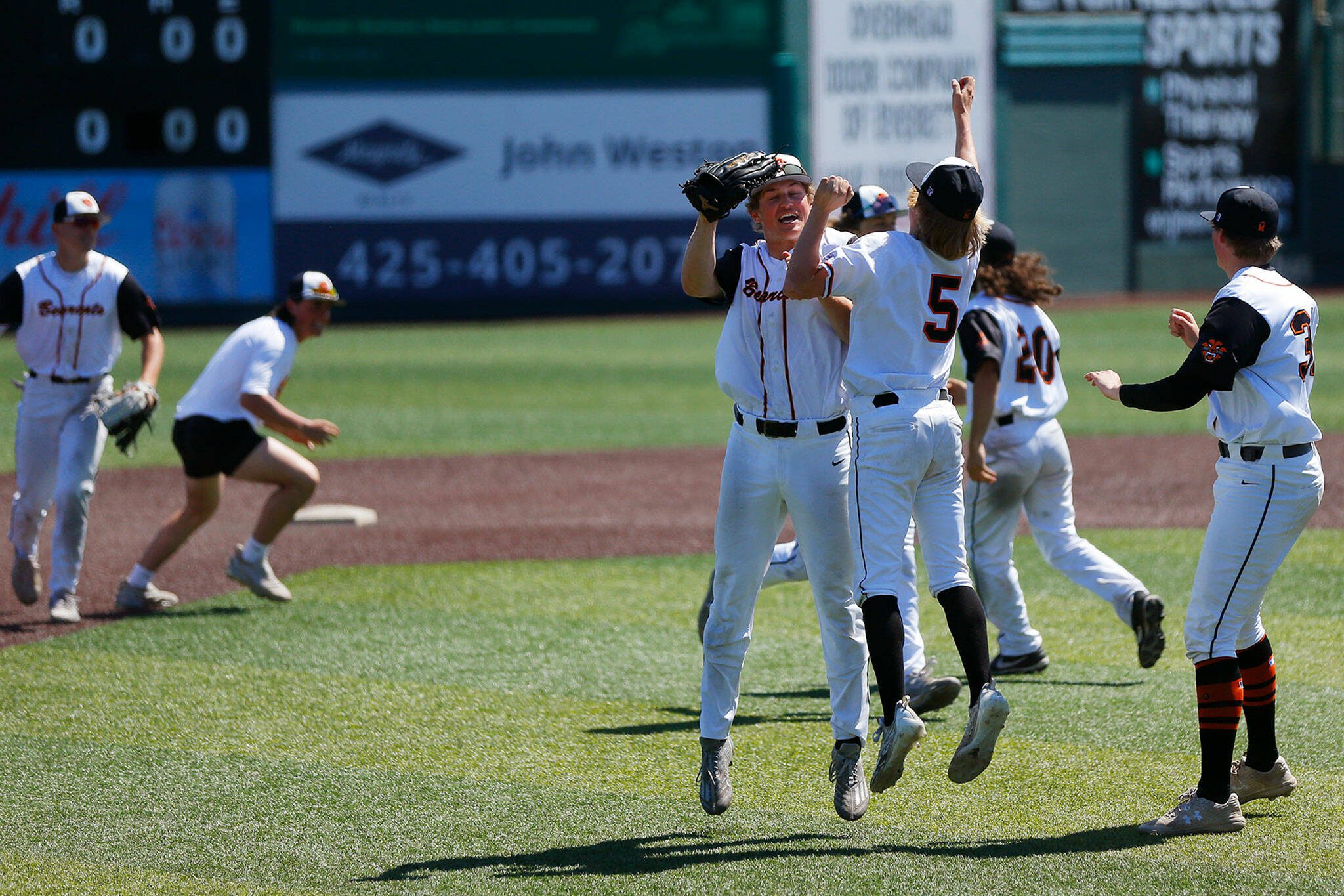 Monroe players begin to celebrate a victory over Stanwood in a winner-to-state consolation game on Saturday, May 13, 2023, at Funko Field in Everett, Washington. (Ryan Berry / The Herald)