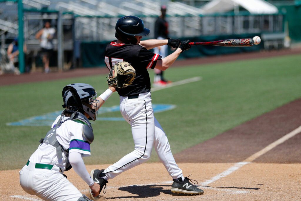 Mountlake Terrace’s Matthew Meadows hits a high fastball for a single against Edmonds-Woodway in the 3A District title game on Saturday, May 13, 2023, at Funko Field in Everett, Washington. (Ryan Berry / The Herald)

