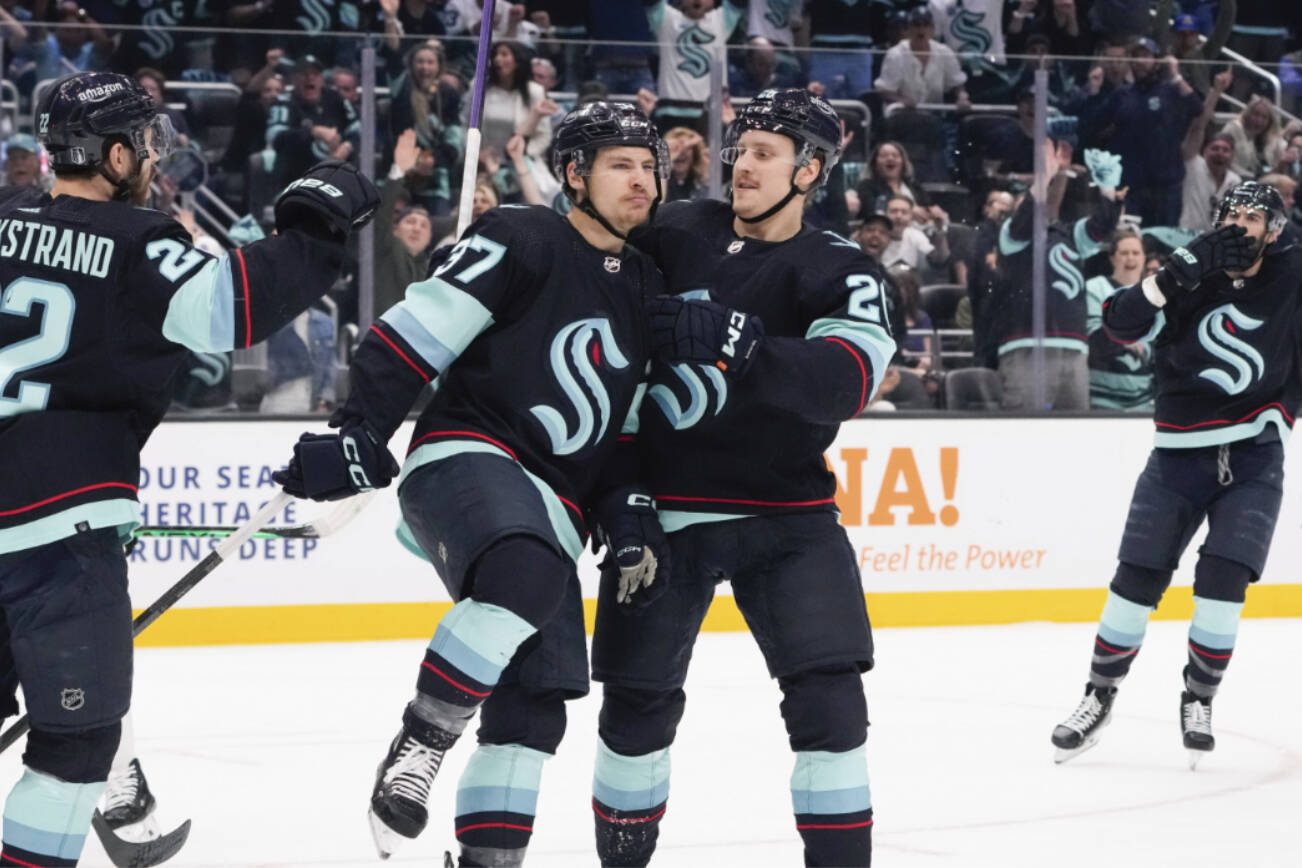 Seattle Kraken center Yanni Gourde (37) celebrates his goal against the Dallas Stars with Oliver Bjorkstrand (22) during the first period of Game 6 of a Stanley Cup second-round playoff series Saturday in Seattle. (AP Photo/Lindsey Wasson)