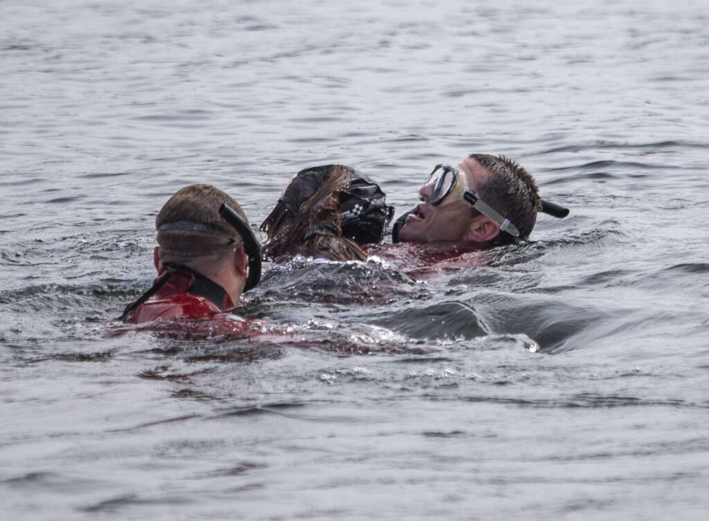 A diver pulls a 150-pound dummy up from the bottom of Lake Stevens during a water rescue demonstration on Tuesday, May 16, 2023 in Lake Stevens, Washington. (Olivia Vanni / The Herald)
