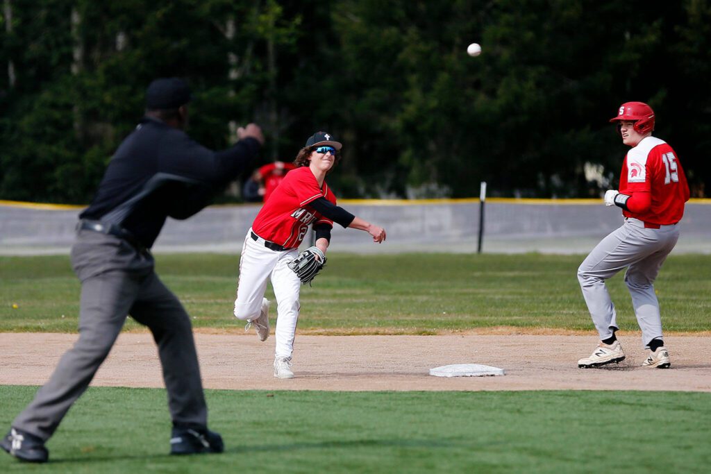 Archbishop Murphy’s Jameson Crow tries to turn a double play against Stanwood on April 28, 2022, at Archbishop Murphy High School in Everett. (Ryan Berry / The Herald)
