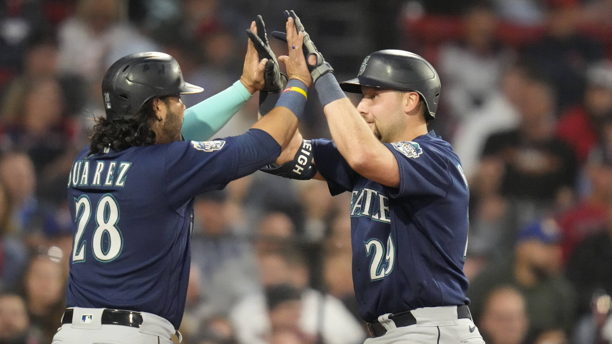 The Mariners’ Cal Raleigh (right) celebrates with Eugenio Suarez after his two-run home run during the fifth inning of a game against the Red Sox on Monday at Fenway Park in Boston. (AP Photo/Charles Krupa)