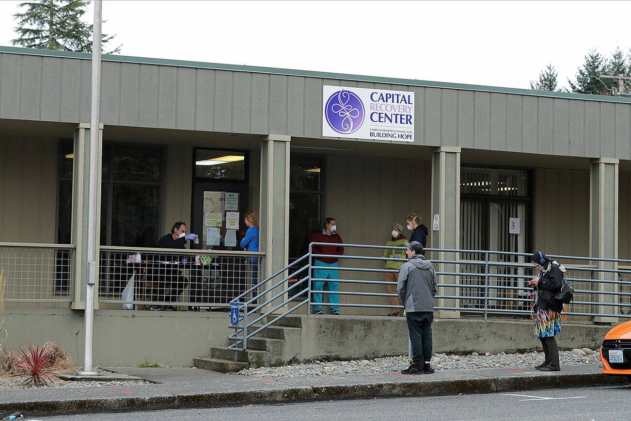FILE - Patients line up to pick up medication for opioid addiction at a clinic in Olympia, Wash., on March 27, 2020. (AP Photo/Ted S. Warren, File)