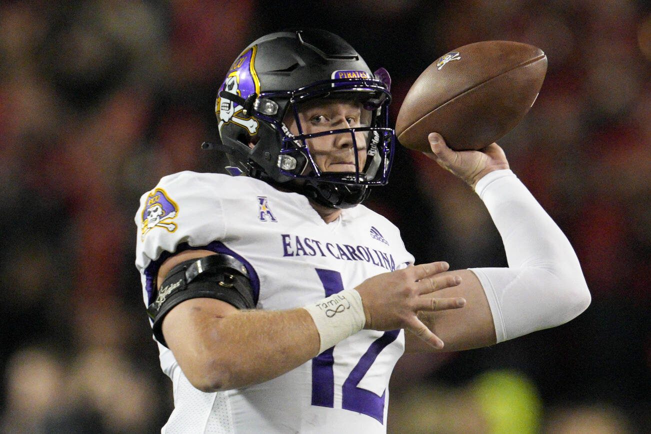 East Carolina quarterback Holton Ahlers (12) plays during the first half of an NCAA college football game against Cincinnati, Friday, Nov. 11, 2022, in Cincinnati. (AP Photo/Jeff Dean)