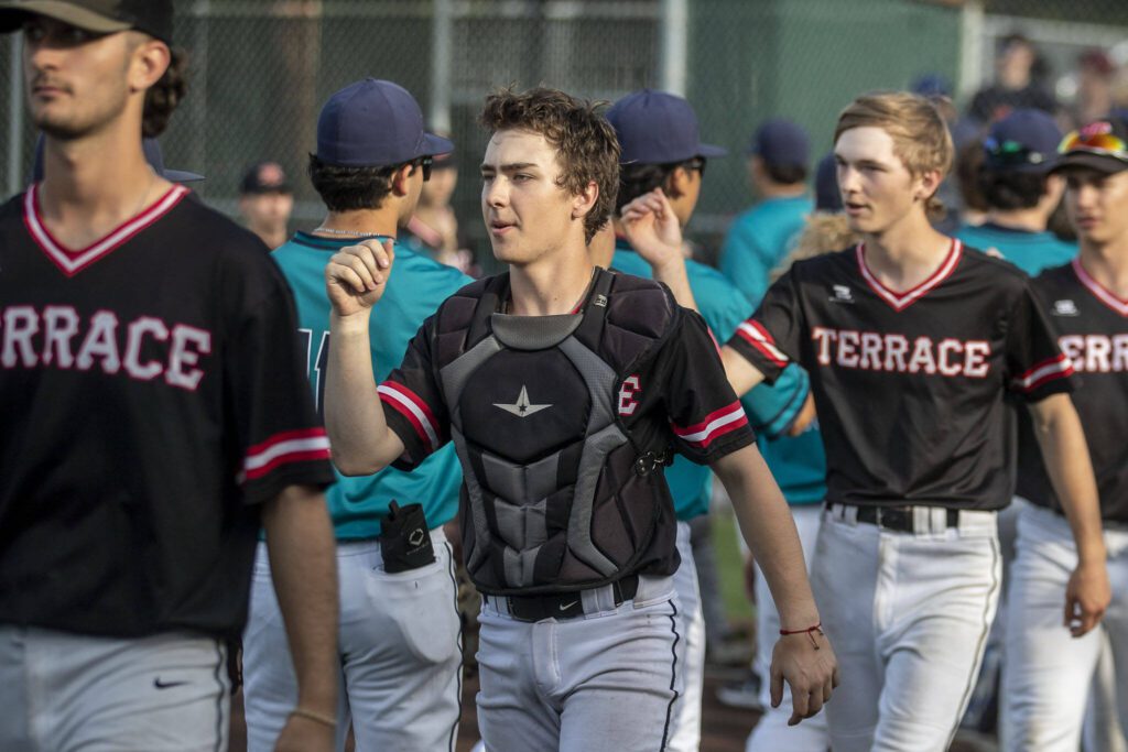 Mountlake Terrace players fist-bump Auburn Riverside players during a game between Mountlake Terrace and Auburn Riverside in Mountlake Terrace, Washington on Tuesday, May 16, 2023. Mountlake Terrace won, 13-3. (Annie Barker / The Herald)

