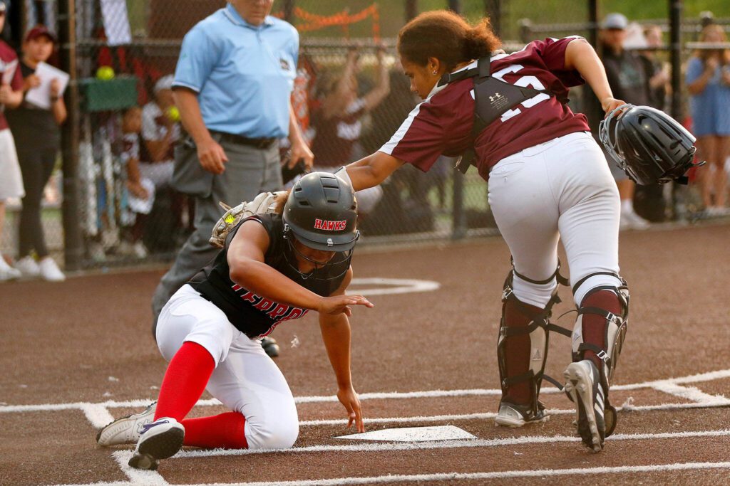 Mountlake Terrace’s Amaya Johnson barely beats the throw home in extras, scoring what would become the game-winning run against Cascade during the Class 3A District 1 softball tournament Tuesday, May 16, 2023, at the Phil Johnson Ballfields in Everett, Washington. (Ryan Berry / The Herald)
