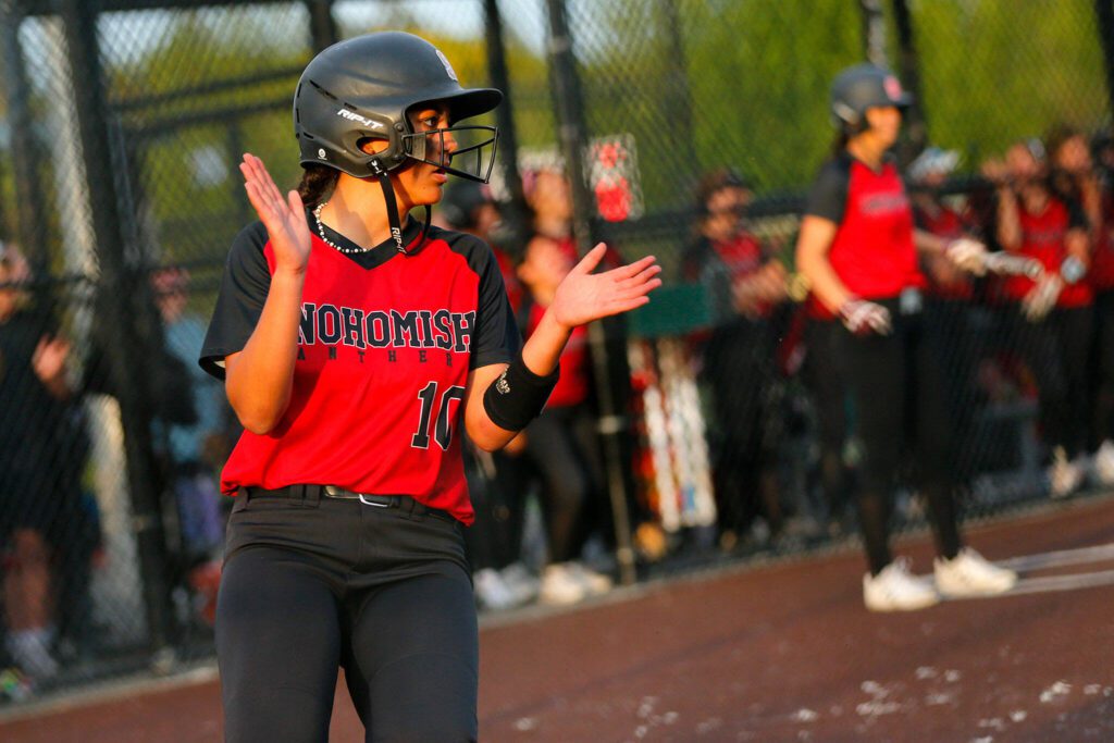 Snohomish’s Emma Hansen claps after crossing the plate to extend the lead over Stanwood during the Class 3A District 1 softball tournament Tuesday, May 16, 2023, at the Phil Johnson Ballfields in Everett, Washington. (Ryan Berry / The Herald)
