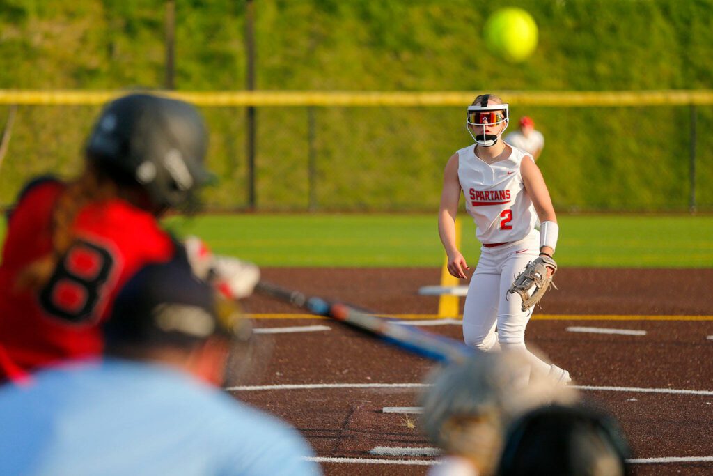 Stanwood pitcher Eliot McDonald watches her pitch go off the bat of Snohomish’s Bridget Johnson during the Class 3A District 1 softball tournament Tuesday, May 16, 2023, at the Phil Johnson Ballfields in Everett, Washington. (Ryan Berry / The Herald)
