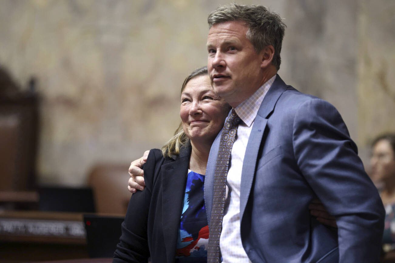 Sen. June Robinson, D-Everett, left, and Sen. Mark Mullet, D-Issaquah, right, embrace after a special session to figure out how much to punish drug possession on Tuesday, May 16, 2023, in Olympia, Wash. Without action, Washington's drug possession law will expire July 1, leaving no penalty in state law and leaving cities free to adopt a hodgepodge of local ordinances.  (Karen Ducey/The Seattle Times via AP)